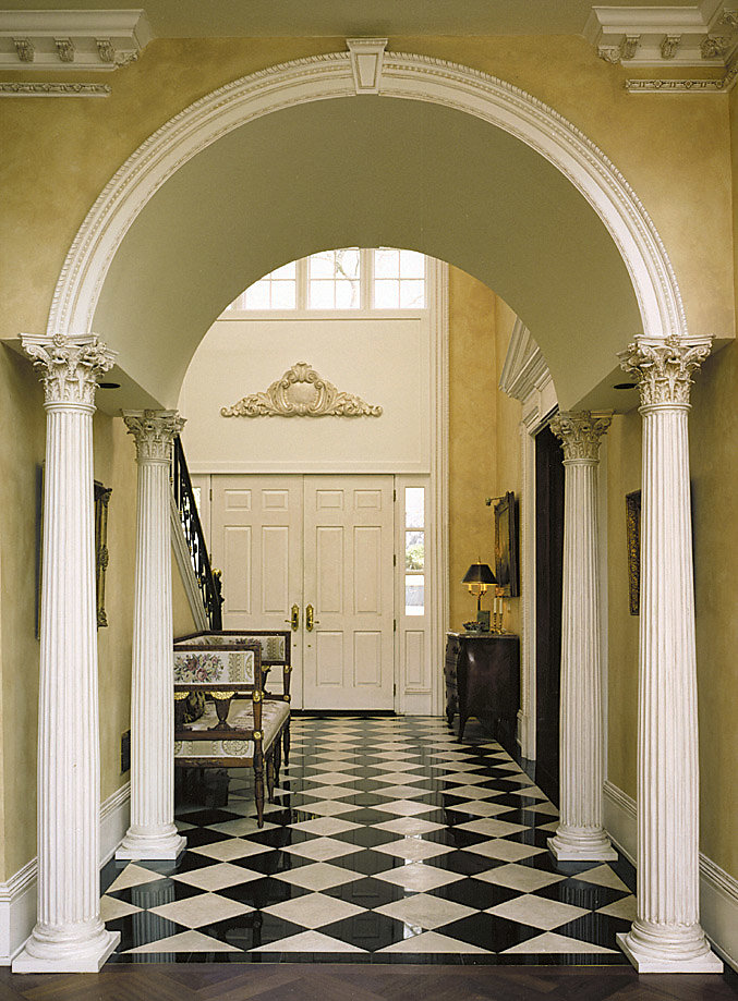 Fluted Corinthian Columns Support an Archway in Foyer